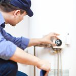 Person fixing a water heater