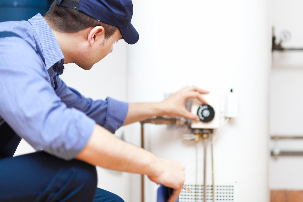 Person fixing a water heater